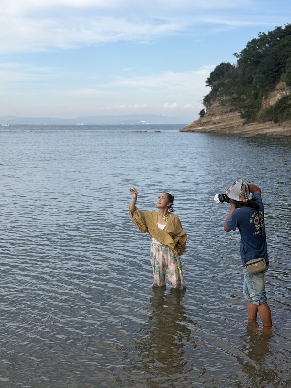 海辺で撮影する二人
